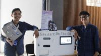 Muhammad Fikri Kusumadinata (kiri) bersama Rajendra Bestian Putra, salah satu rekan pengembang Sanitary On The Go, saat pameran FIPEC 2026 di Departemen Teknik Elektro Otomasi ITS